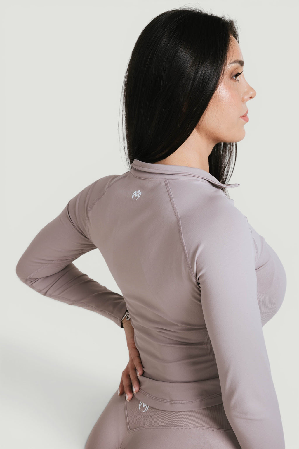 A N A M E Core Jacket in Mocha Cappuccino, a long-sleeve performance top worn by a model against a neutral background.