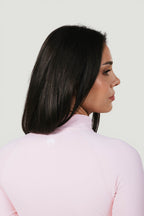 A N A M E Core Jacket in pink rose, featuring a mock neck and performance fabric on a model from the back.