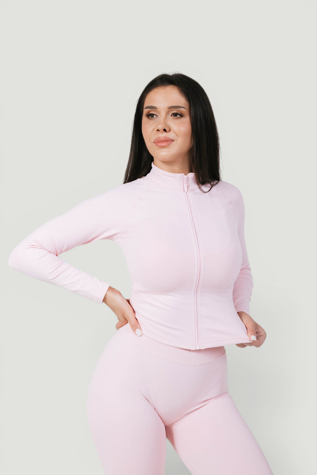 A N A M E Core Jacket in pink rose, a long-sleeve performance zip-up worn by a model against a neutral background.