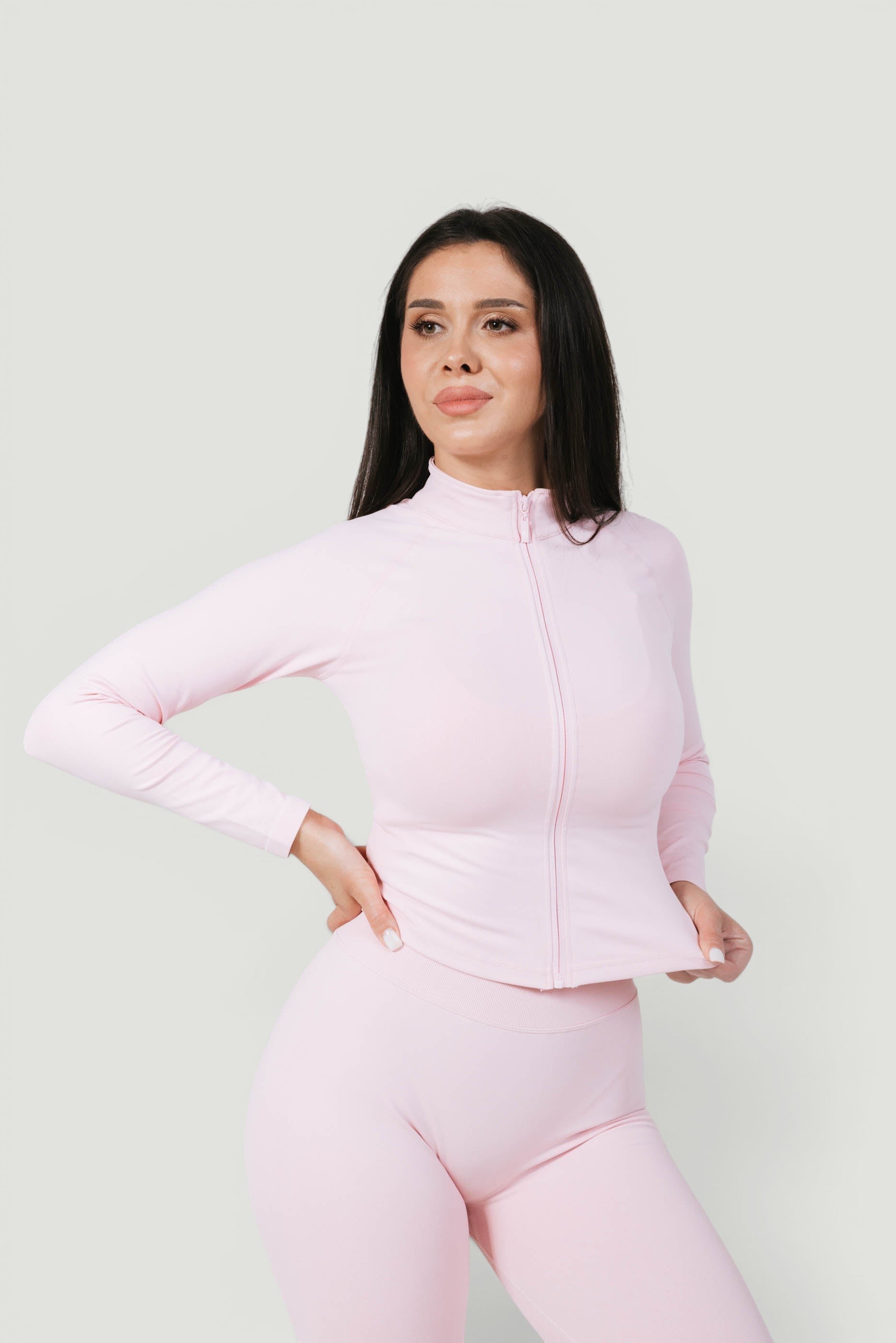 A N A M E Core Jacket in pink rose, a long-sleeve performance zip-up worn by a model against a neutral background.