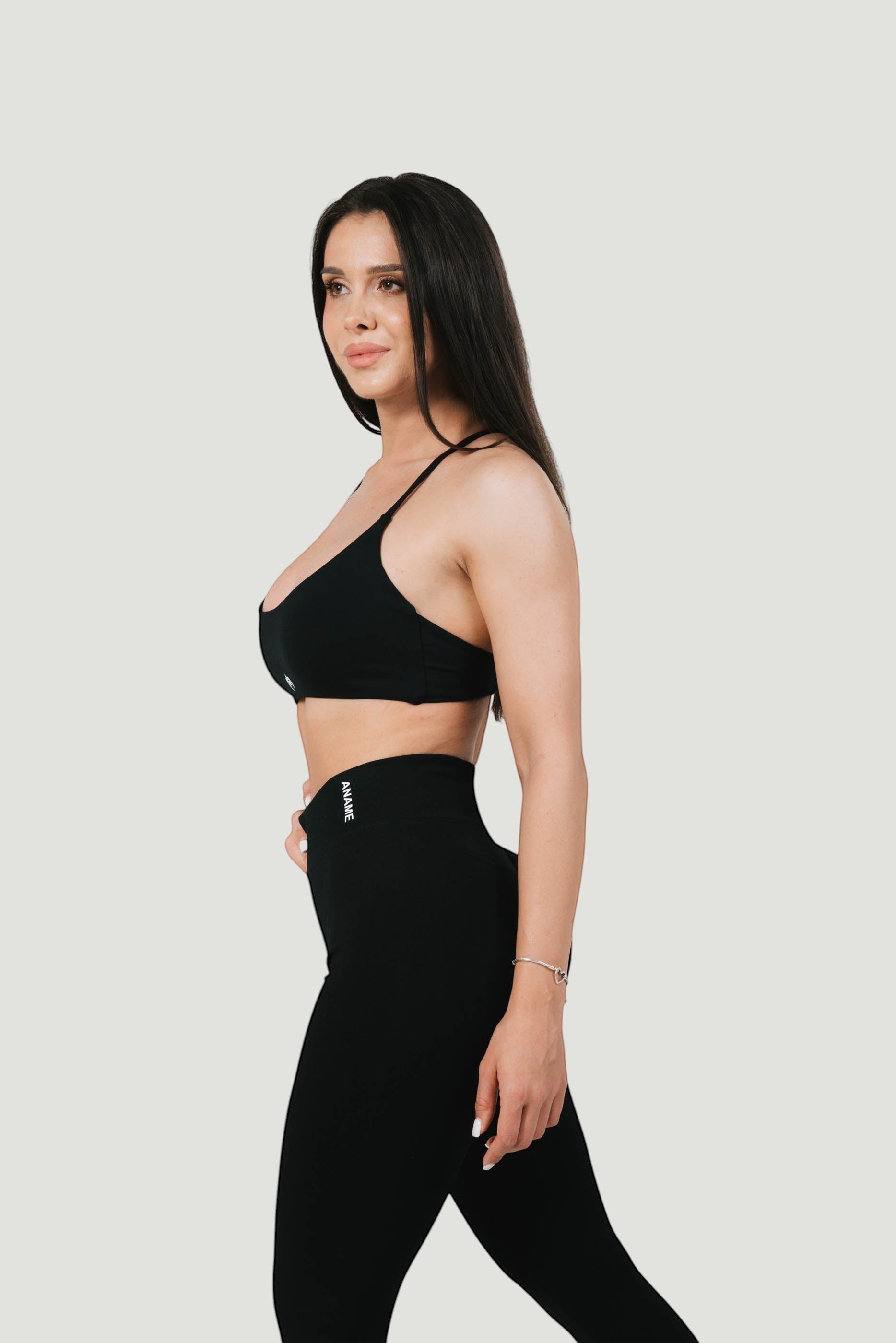 A N A M E high-waist black midnight leggings on a model, featuring a supportive, sculpting fit for a refined silhouette