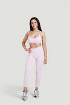 A N A M E high-waist pink rose leggings and matching sports bra worn by a woman for a sculpted athletic look.