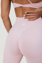 A N A M E pink rose high-waist leggings with a sculpted fit and subtle logo detail on a model.
