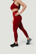 A N A M E high-waist red wine leggings on a model, featuring a supportive, sculpted fit for a refined athletic look.